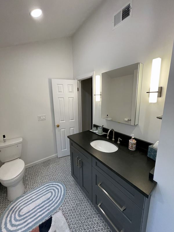 Bathroom with black vanity and quartz top