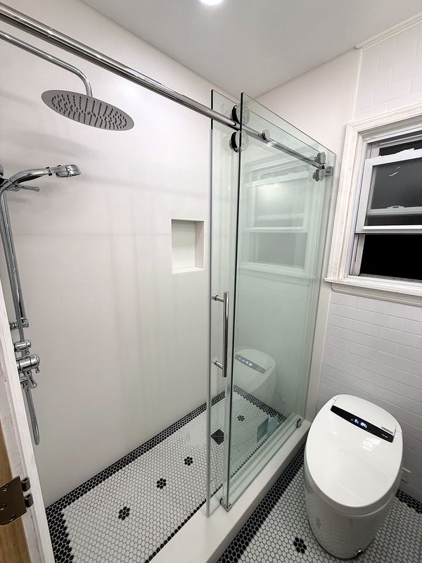 Frameless sliding glass shower with hex mosaic floor