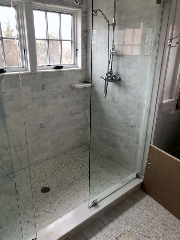 Marble subway tile shower with frameless glass