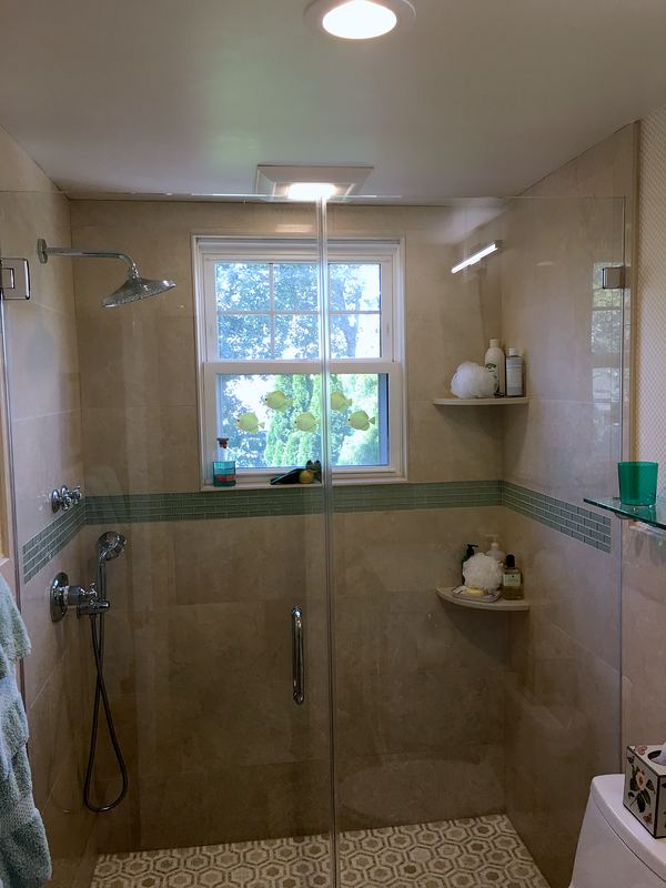 Walk-in shower with glass accent band and window