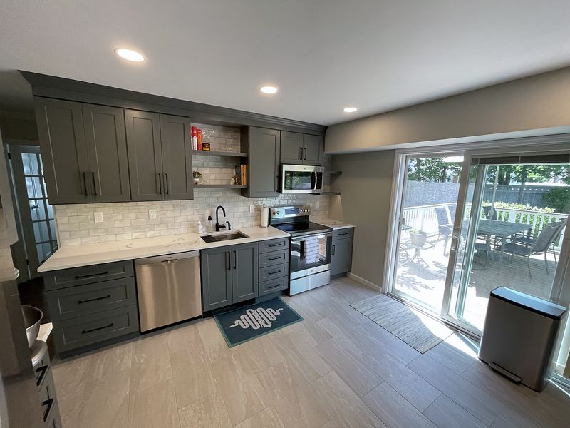 Gray shaker kitchen with open shelves and patio door
