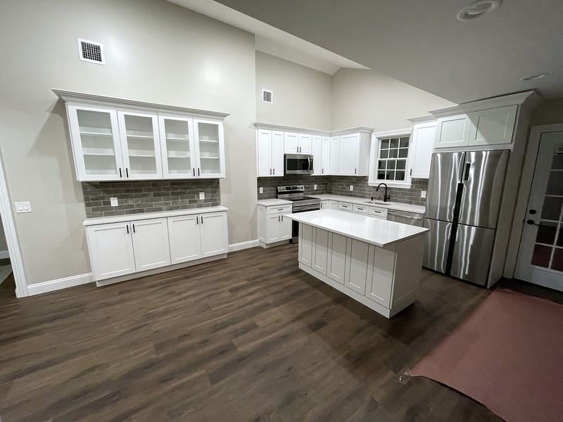 White kitchen with glass-front hutch and island